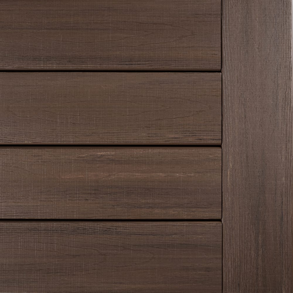 Close-up of Landmark American Walnut APVC siding panels with horizontal grain and vertical trim.