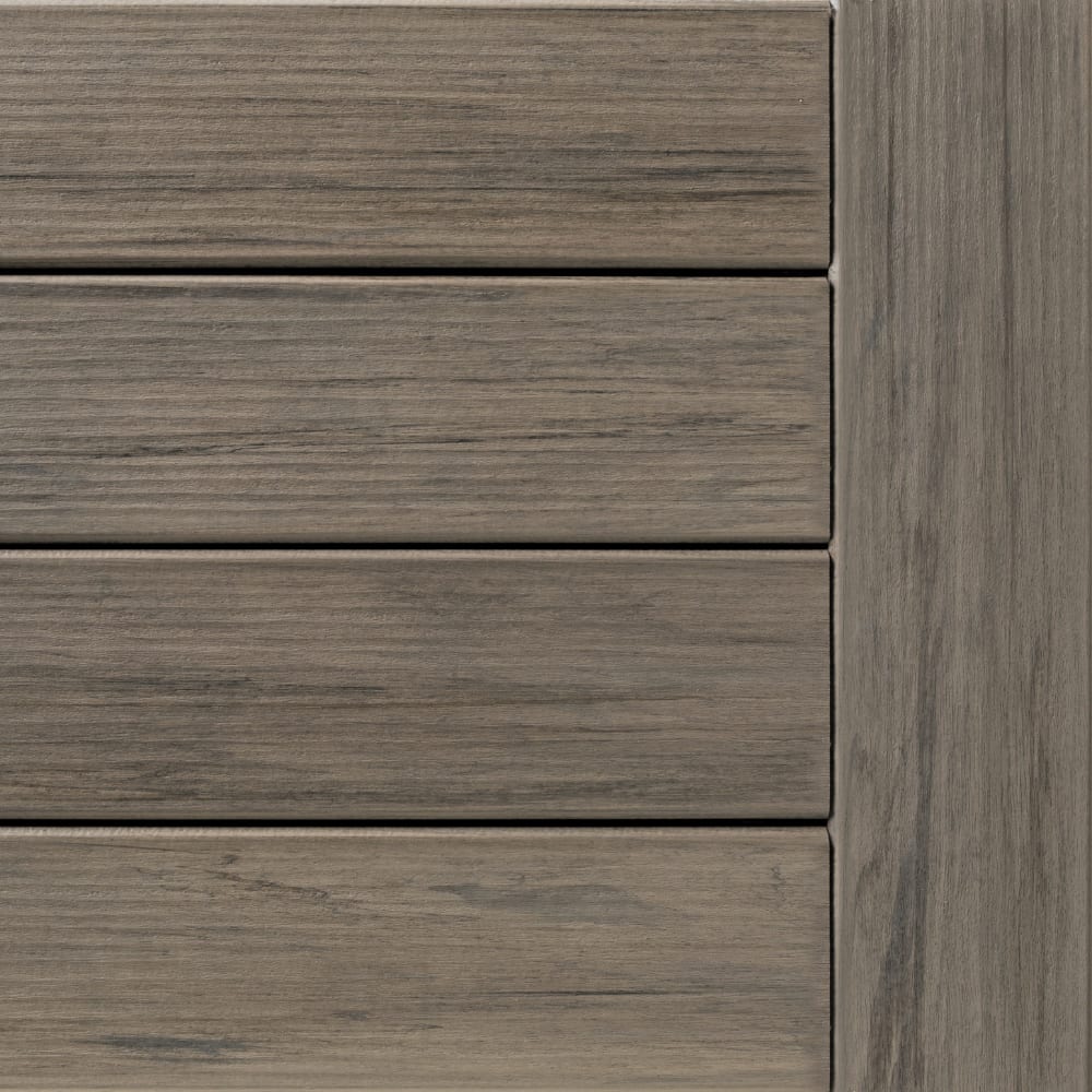 Close-up of Legacy Ashwood composite decking, showing horizontal planks with subtle wood grain texture and a vertical edge panel.
