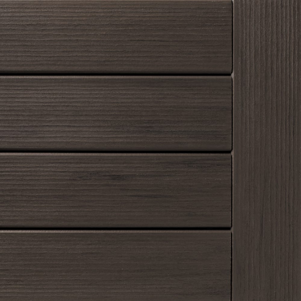Close-up of Legacy Espresso composite decking with horizontal slats and a vertical end board showing dark wood-grain texture.