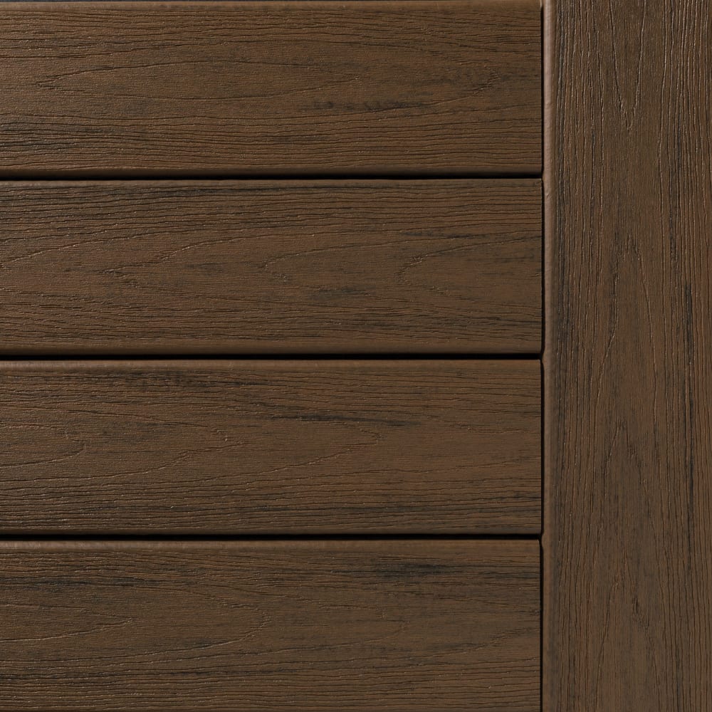 Close-up of TimberTech Reserve Dark Roast composite decking, showing horizontal planks with a vertical trim piece to the right.